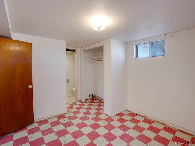 basement with light floors and a textured ceiling