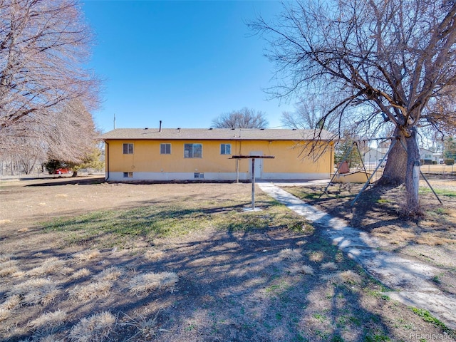 rear view of property featuring crawl space