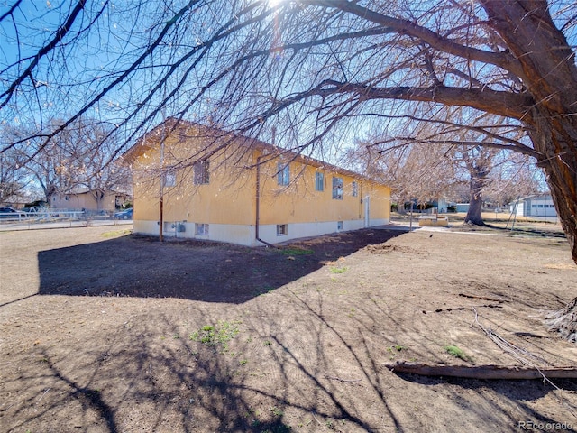 view of home's exterior featuring fence