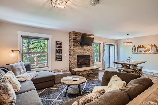 815 Columbine Rd Unit 22, Breckenridge, CO 80424 - living room with plenty of natural light, a stone fireplace, and wood finished floors