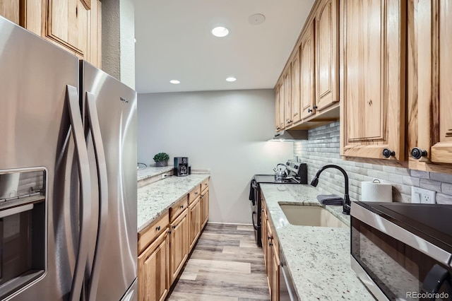 815 Columbine Rd Unit 22, Breckenridge, CO 80424 - kitchen featuring appliances with stainless steel finishes, light wood-style flooring, decorative backsplash, recessed lighting, and light stone countertops