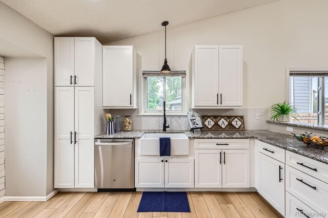 3455 Sun River Pl, Colorado Springs, CO 80920 - kitchen with dishwasher, a sink, light wood finished floors, white cabinetry, and lofted ceiling