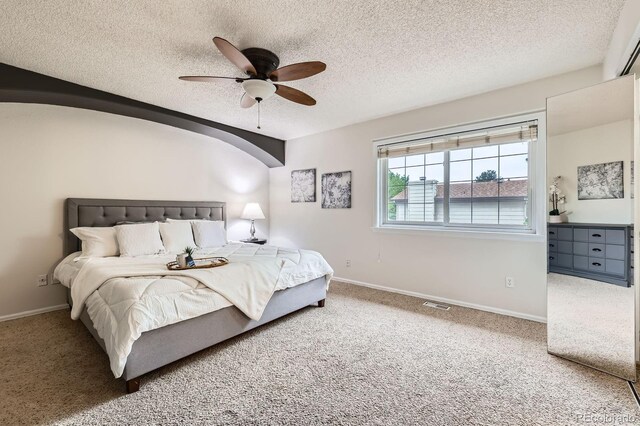 3455 Sun River Pl, Colorado Springs, CO 80920 - carpeted bedroom with a textured ceiling, baseboards, ceiling fan, and arched walkways