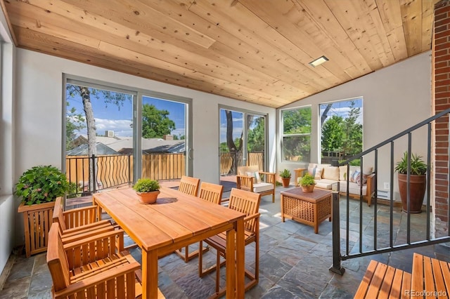 sunroom / solarium with lofted ceiling and wooden ceiling