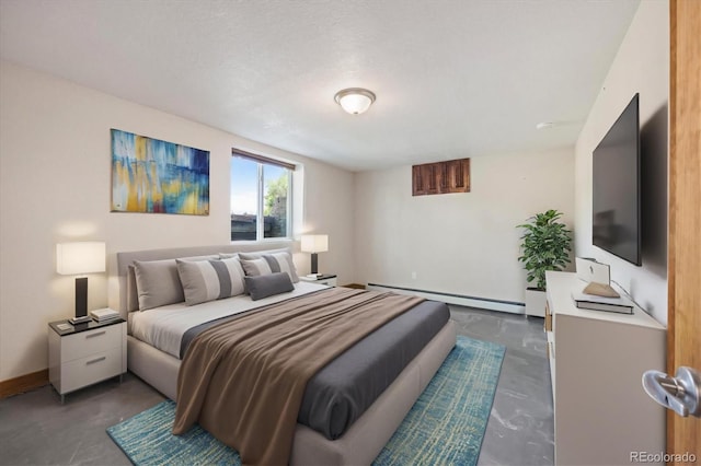 bedroom with a baseboard heating unit and a textured ceiling