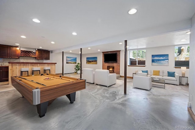 rec room featuring pool table, indoor wet bar, and a fireplace