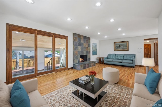 living room featuring hardwood / wood-style floors and a tiled fireplace