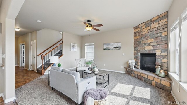 8308 Needle Drop Ct, Colorado Springs, CO 80908 - living area with a stone fireplace, ceiling fan, and stairs