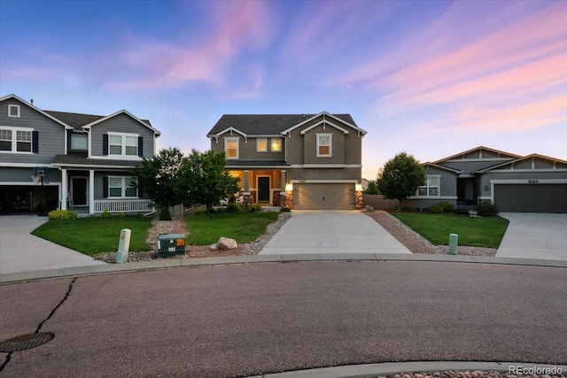 8308 Needle Drop Ct, Colorado Springs, CO 80908 - view of front of home with driveway, a yard, stucco siding, and an attached garage