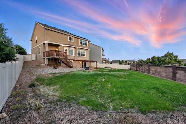 8308 Needle Drop Ct, Colorado Springs, CO 80908 - rear view of house featuring a fenced backyard, stairs, a wooden deck, and stucco siding