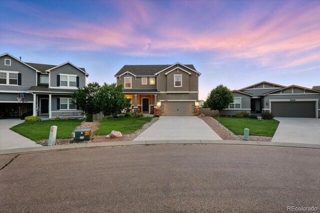 8308 Needle Drop Ct, Colorado Springs, CO 80908 - view of front of home featuring concrete driveway, a lawn, and stucco siding