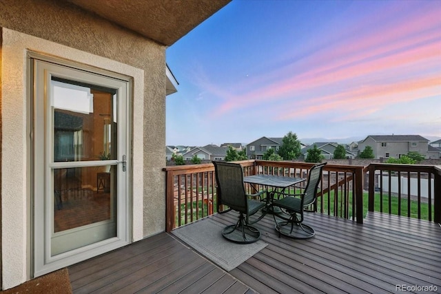 8308 Needle Drop Ct, Colorado Springs, CO 80908 - deck at dusk featuring outdoor dining space and a residential view