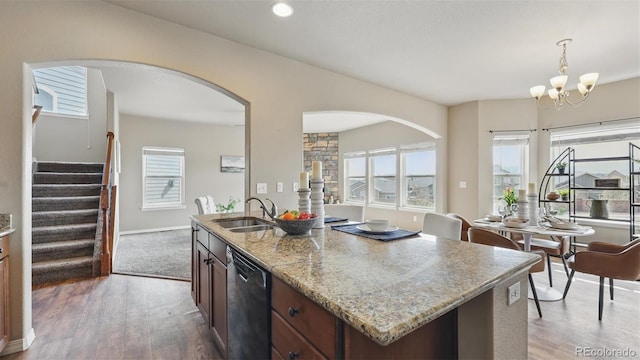 8308 Needle Drop Ct, Colorado Springs, CO 80908 - kitchen with dishwasher, light wood finished floors, light stone countertops, a chandelier, and plenty of natural light