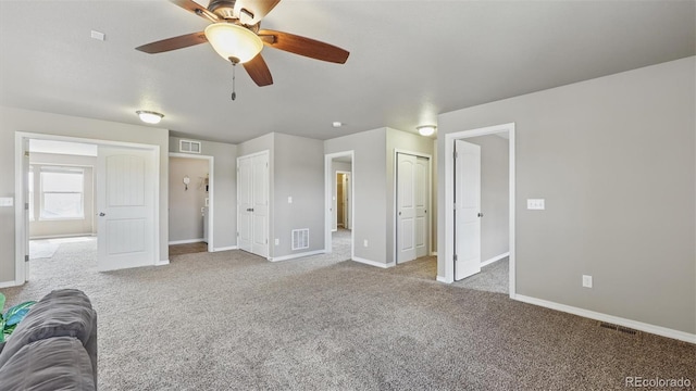 8308 Needle Drop Ct, Colorado Springs, CO 80908 - unfurnished bedroom with two closets, carpet, and ceiling fan