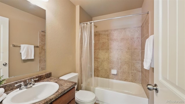 8308 Needle Drop Ct, Colorado Springs, CO 80908 - full bathroom with vanity, shower / bath combo with shower curtain, and a textured wall