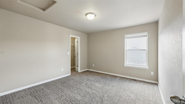 8308 Needle Drop Ct, Colorado Springs, CO 80908 - unfurnished room featuring carpet flooring and attic access