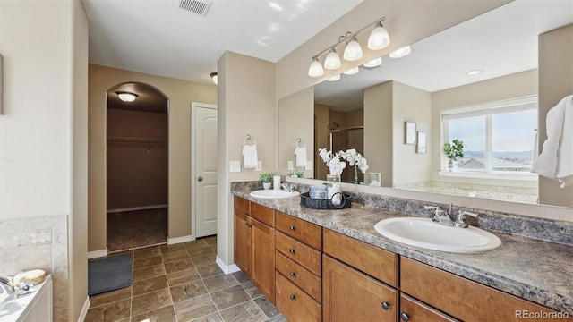 8308 Needle Drop Ct, Colorado Springs, CO 80908 - full bathroom with a shower stall, double vanity, a spacious closet, and a tub