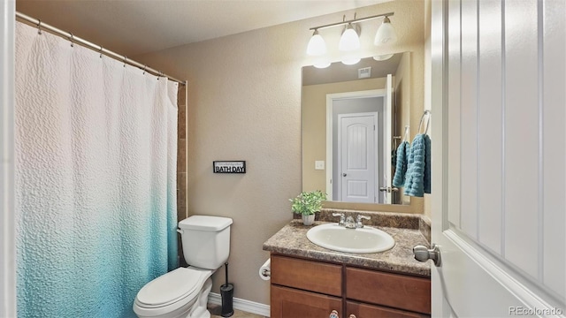 8308 Needle Drop Ct, Colorado Springs, CO 80908 - bathroom with vanity, curtained shower, and a textured wall