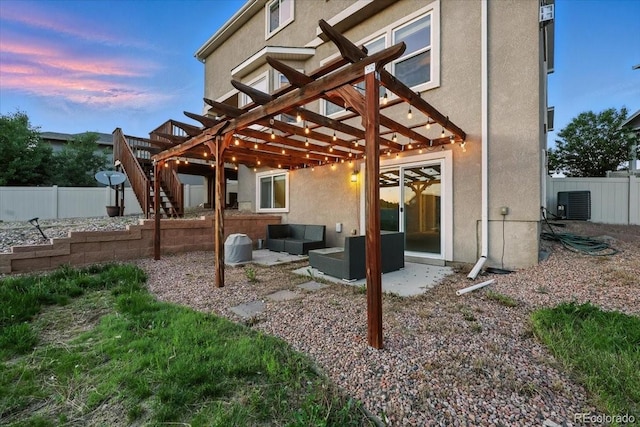 8308 Needle Drop Ct, Colorado Springs, CO 80908 - back of house with outdoor lounge area, a pergola, stucco siding, and a patio area