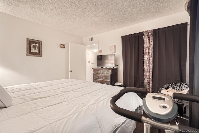 bedroom with visible vents and a textured ceiling