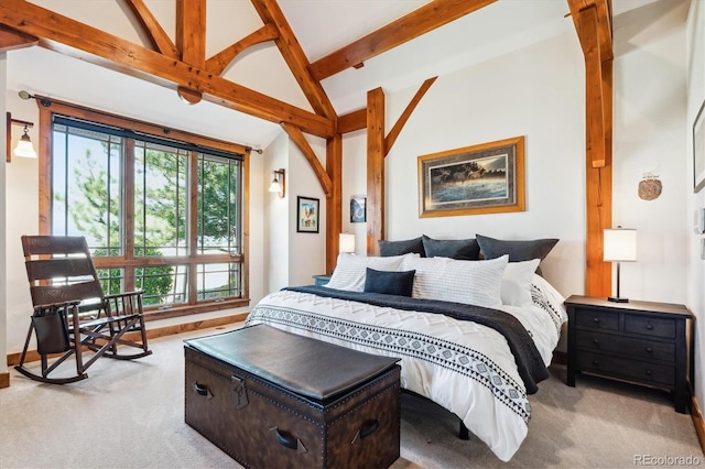 bedroom with lofted ceiling with beams and light carpet