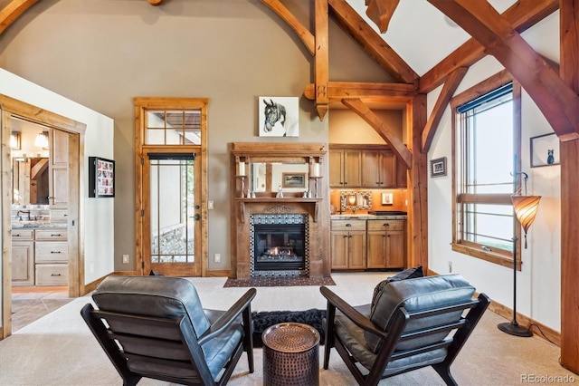 living room featuring light colored carpet, high vaulted ceiling, and beamed ceiling