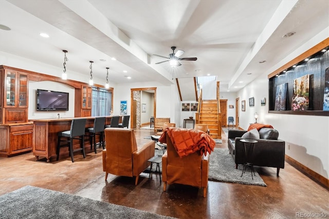 living room featuring ceiling fan and indoor bar