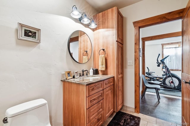 bathroom featuring vanity, toilet, and tile patterned flooring