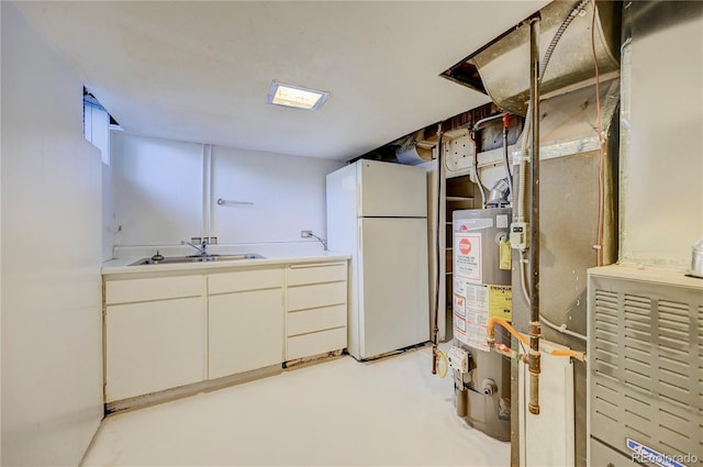 4130 S Elati St, Englewood, CO 80110 - below grade area featuring freestanding refrigerator and gas water heater