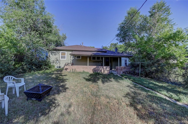 4130 S Elati St, Englewood, CO 80110 - back of house featuring an outdoor fire pit and a lawn