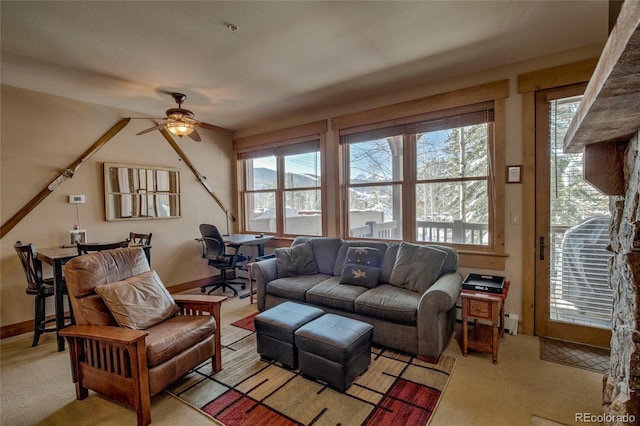 carpeted living room with ceiling fan and a wealth of natural light