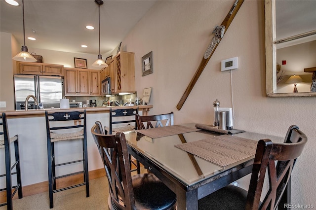 carpeted dining room with sink