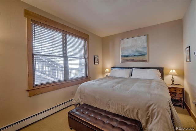 carpeted bedroom featuring baseboard heating