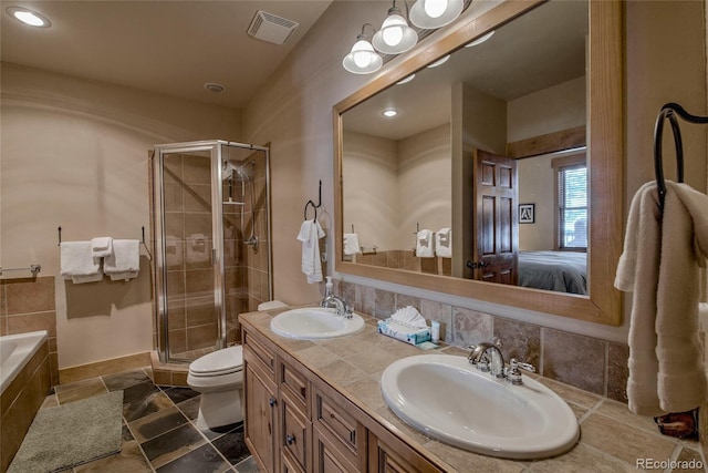 full bathroom featuring shower with separate bathtub, vanity, and toilet