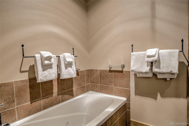 bathroom with tiled bath