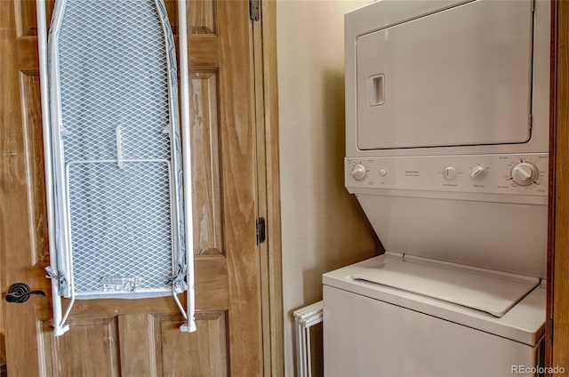 washroom featuring stacked washer / drying machine