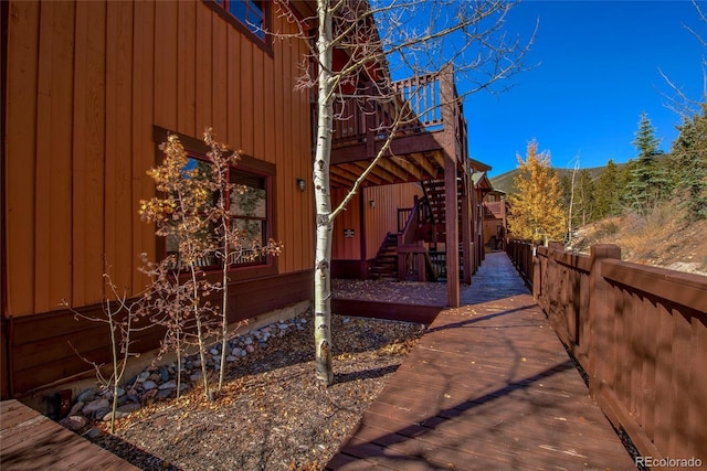 view of property exterior with a wooden deck