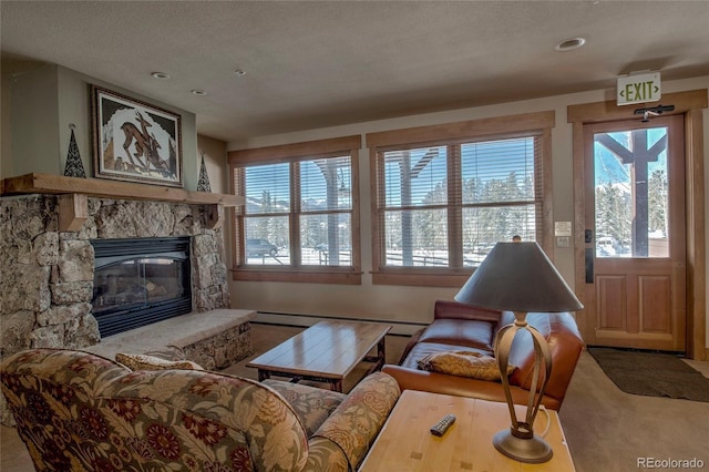 living room featuring a stone fireplace, carpet floors, a textured ceiling, and baseboard heating