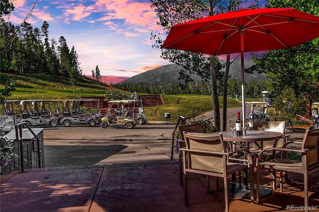 patio terrace at dusk featuring a mountain view