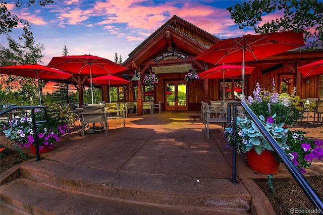 patio terrace at dusk featuring french doors