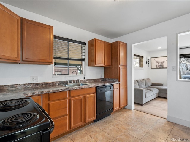 kitchen with sink, light tile patterned floors, and black appliances