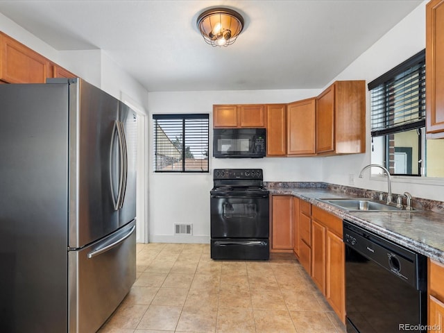 kitchen with sink, light tile patterned floors, and black appliances