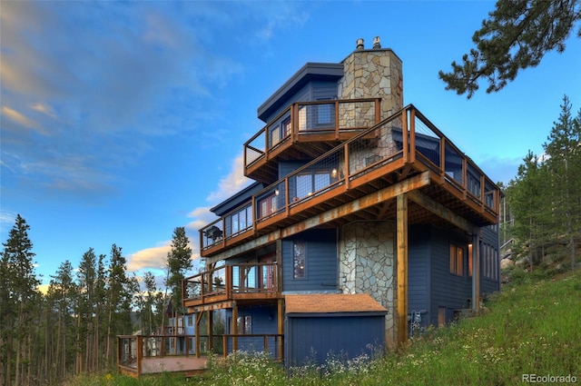 back of property featuring a balcony