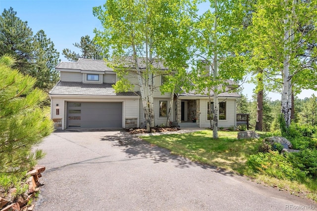 2122 Cramner Ct, Evergreen, CO 80439 - view of front of property with driveway, a garage, stone siding, and a front yard