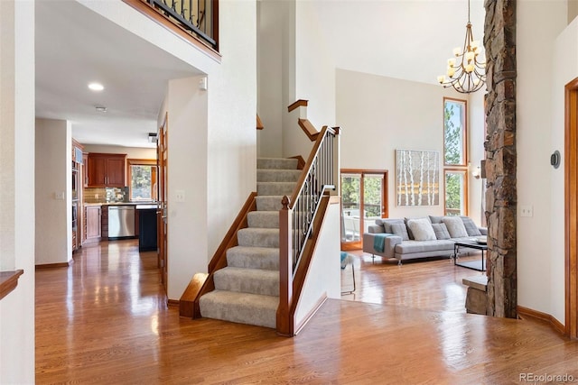 2122 Cramner Ct, Evergreen, CO 80439 - foyer with a high ceiling, a chandelier, wood finished floors, plenty of natural light, and stairway