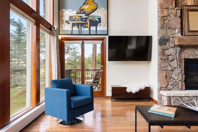 2122 Cramner Ct, Evergreen, CO 80439 - living area with plenty of natural light, wood finished floors, and a fireplace