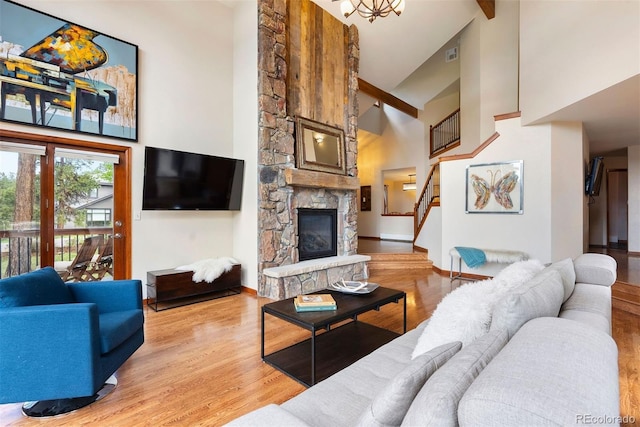 2122 Cramner Ct, Evergreen, CO 80439 - living area with high vaulted ceiling, stairs, a fireplace, light wood-style floors, and baseboards
