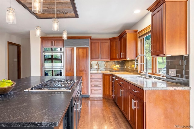 2122 Cramner Ct, Evergreen, CO 80439 - kitchen with a sink, appliances with stainless steel finishes, wood finished floors, and brown cabinets