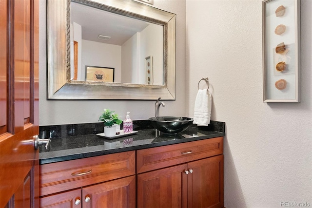 2122 Cramner Ct, Evergreen, CO 80439 - bathroom featuring a textured wall and vanity
