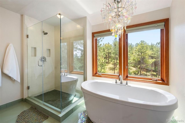 2122 Cramner Ct, Evergreen, CO 80439 - bathroom with a chandelier, a shower stall, a freestanding tub, tile patterned flooring, and baseboards
